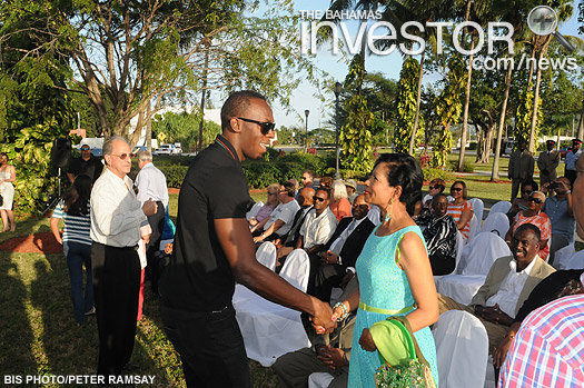 Rose Marie Davis, wife of Deputy Prime Minister Philip Davis, greets Jamaican track star Usain Bolt