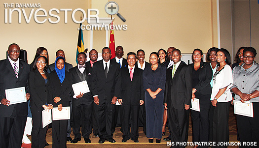 Cabinet ministers, senior government officials and stakeholders pose with the Bahamians who received scholarships to attend university in the People’s Republic of China